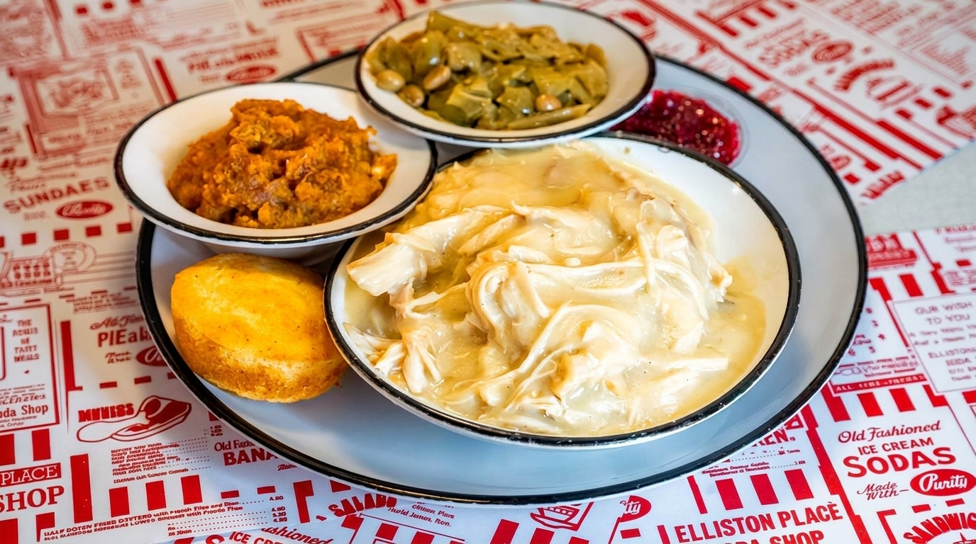 A Southern comfort food meal with chicken and dumplings, sweet potatoes, and collard greens.