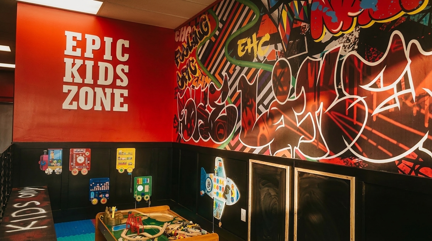 A vibrant kids' play area with "EPIC KIDS ZONE" on a red wall and colorful graffiti art.