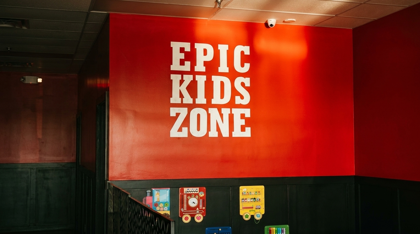 A bright red wall with "EPIC KIDS ZONE" in white letters above interactive play panels.