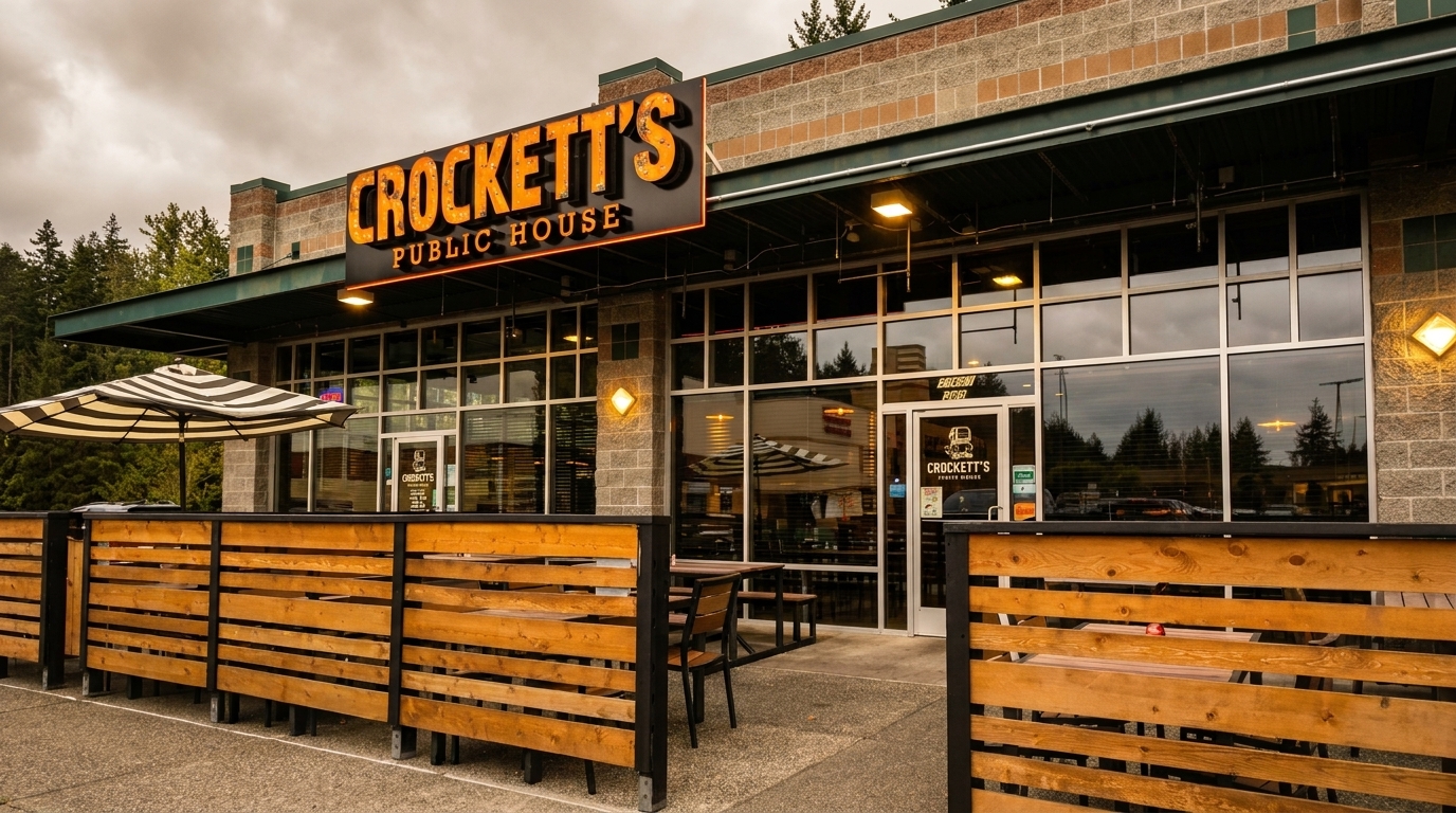 Exterior of Crockett's Public House with outdoor patio seating and a striped umbrella.