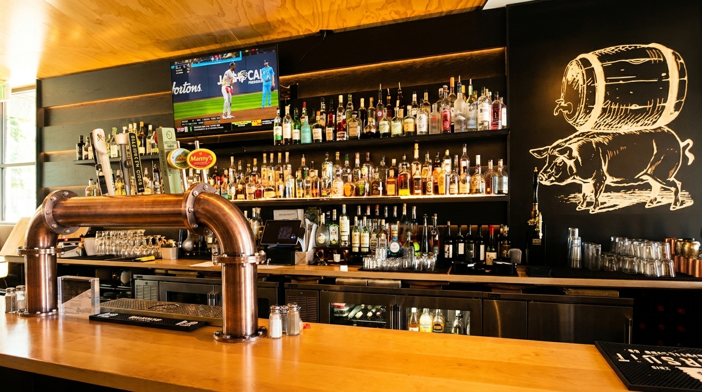 A well-stocked bar with a large TV, beer taps, and a pig and barrel mural on the wall.