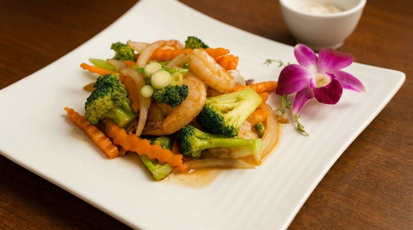 Shrimp and vegetable stir-fry with broccoli, carrots, and onions, garnished with an orchid.