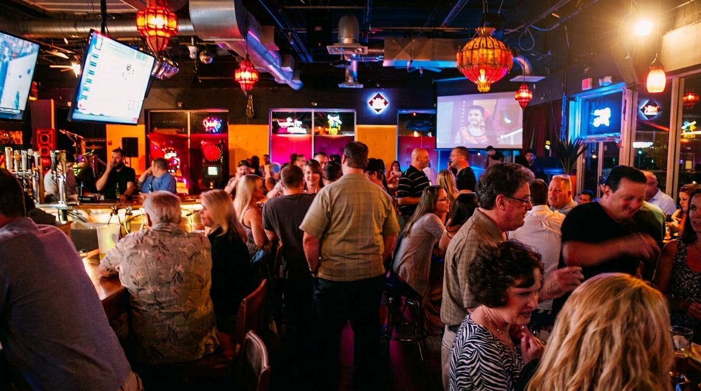 A lively bar scene with many patrons socializing, drinking, and watching sports on multiple screens.