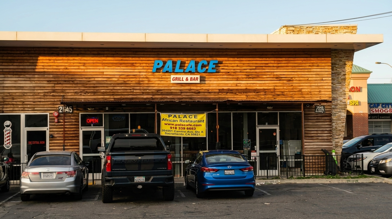 The exterior of Palace Grill & Bar, an African restaurant, with a wooden facade and parked cars.