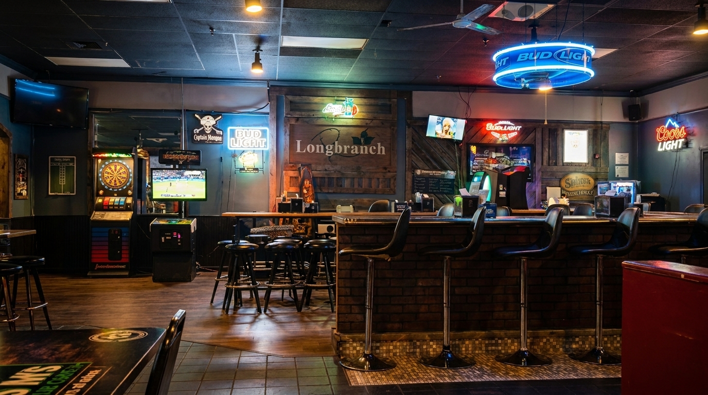 Interior of Longbranch bar with neon signs, dartboard, arcade games, and bar stools.