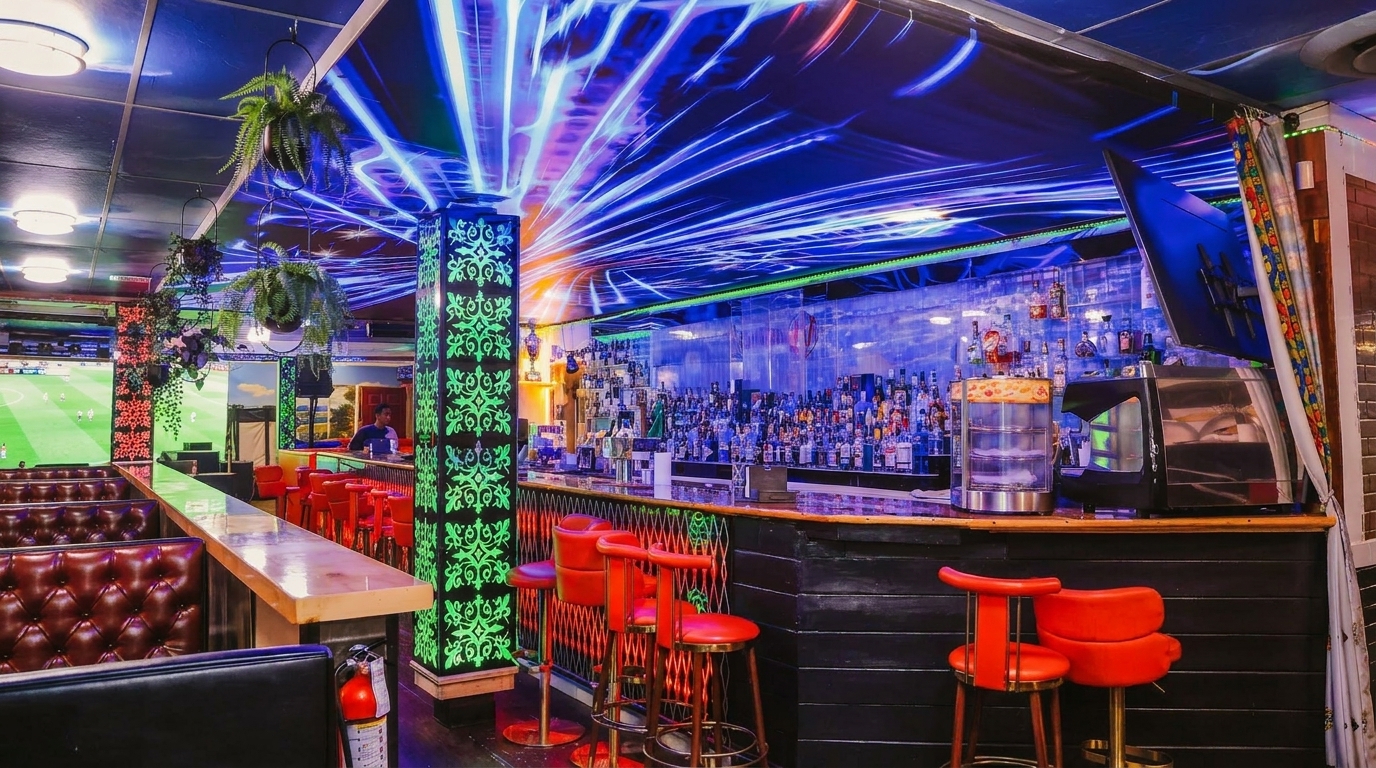 A vibrant bar interior with neon blue ceiling lights, red bar stools, and a fully stocked liquor bar.