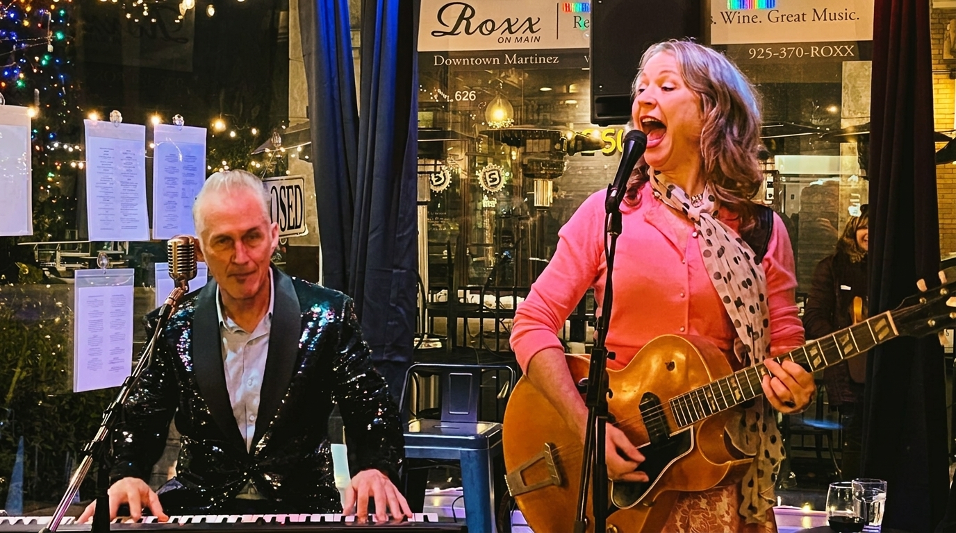A man playing piano and a woman singing and playing guitar at Roxx on Main.