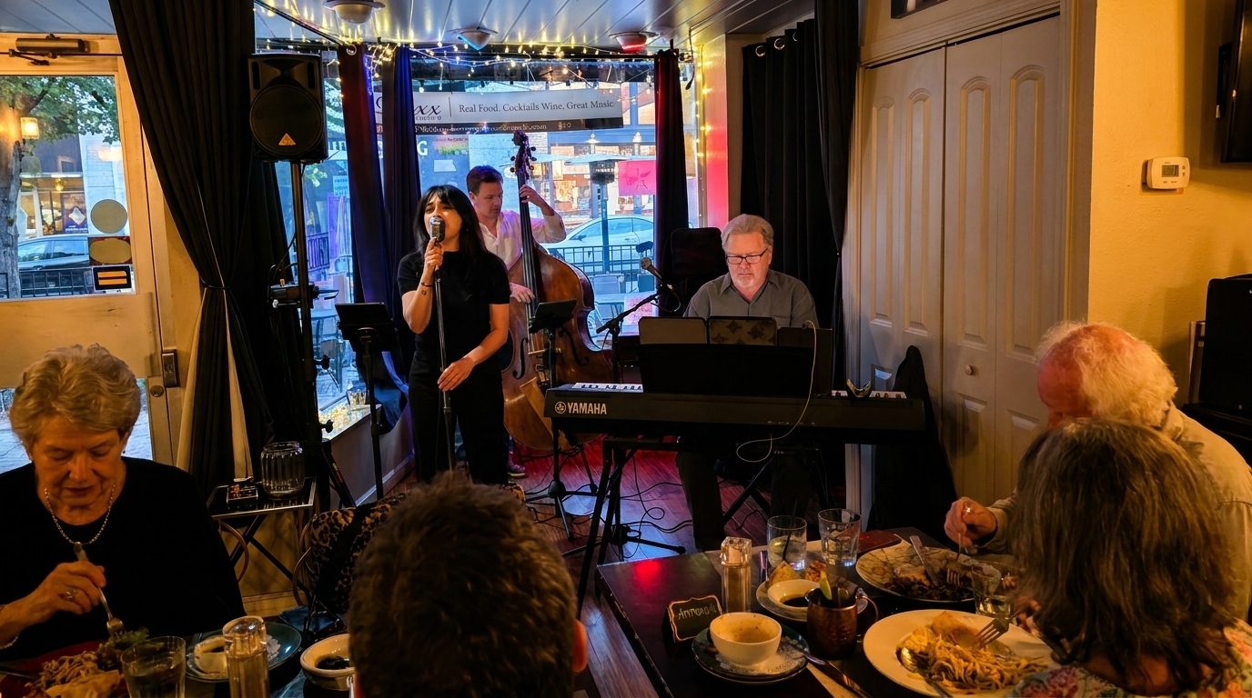 Diners enjoy a meal while a jazz trio performs live music in a cozy restaurant setting.