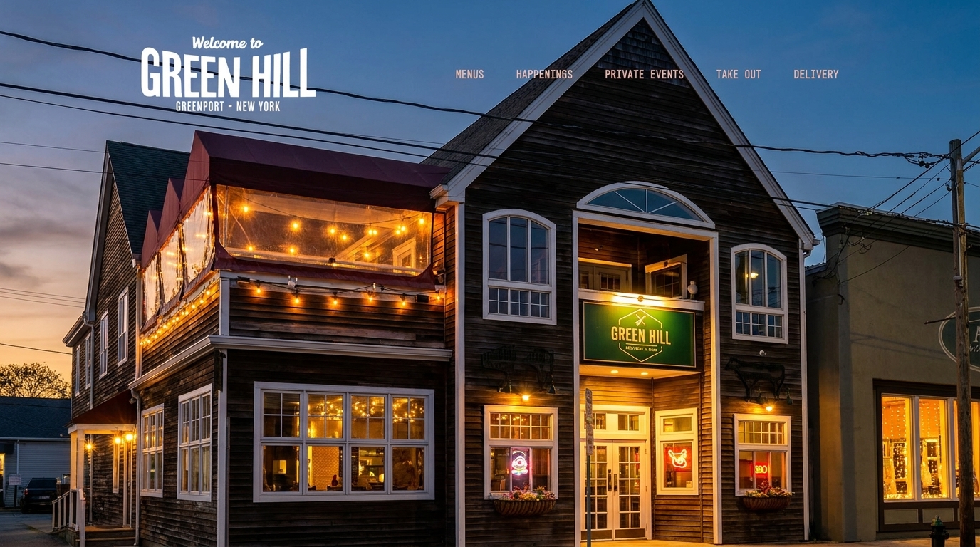 The Green Hill restaurant exterior at dusk, with illuminated windows, string lights, and a green sign.