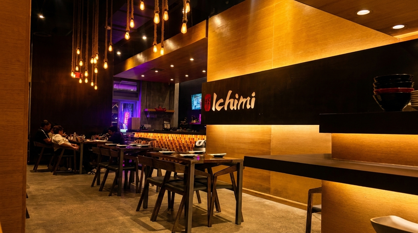 Ichimi restaurant interior with warm lighting, wooden tables, and diners enjoying their meals.