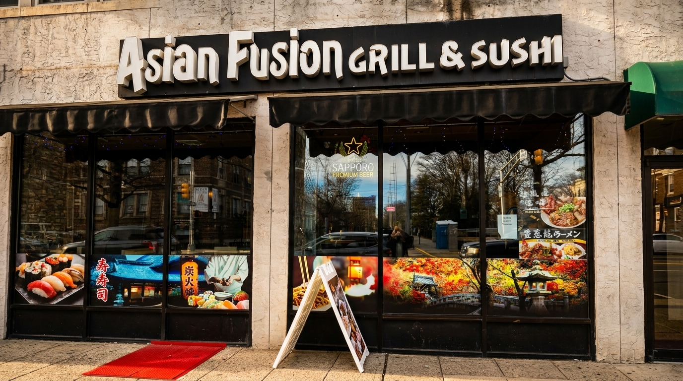 Exterior of Asian Fusion Grill & Sushi restaurant with large windows displaying food and scenic images.