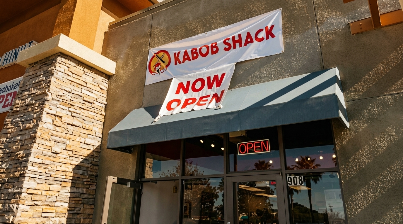 Kabob Shack restaurant exterior with a "Now Open" banner above the entrance and an "Open" sign in the window.