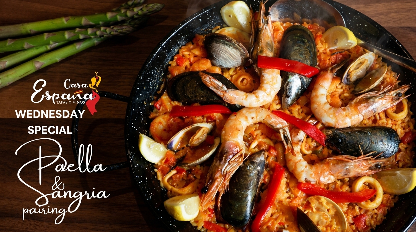 Close-up of a Casa España paella with shrimp, mussels, clams, and red peppers, garnished with lemon.