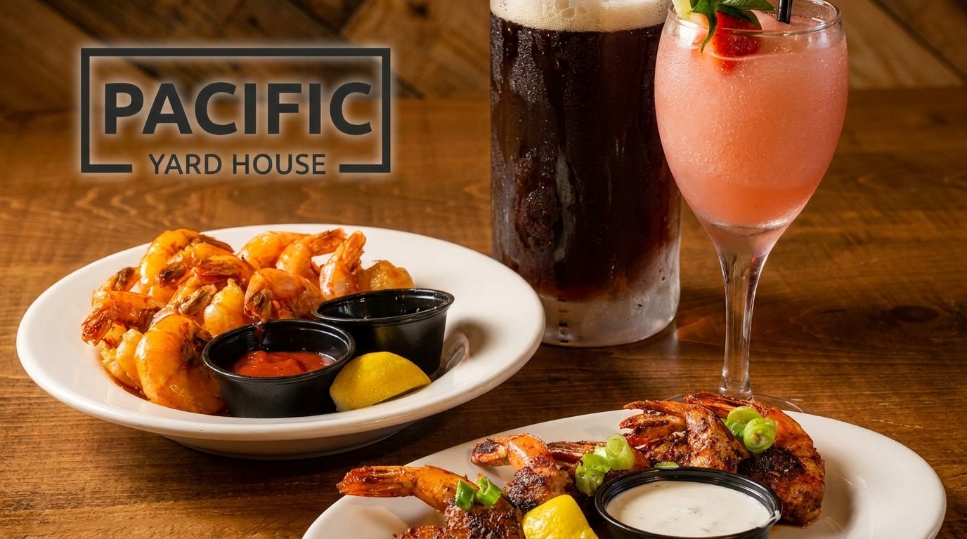 Plates of shrimp with dipping sauces and lemon, alongside a beer and a pink frozen drink.