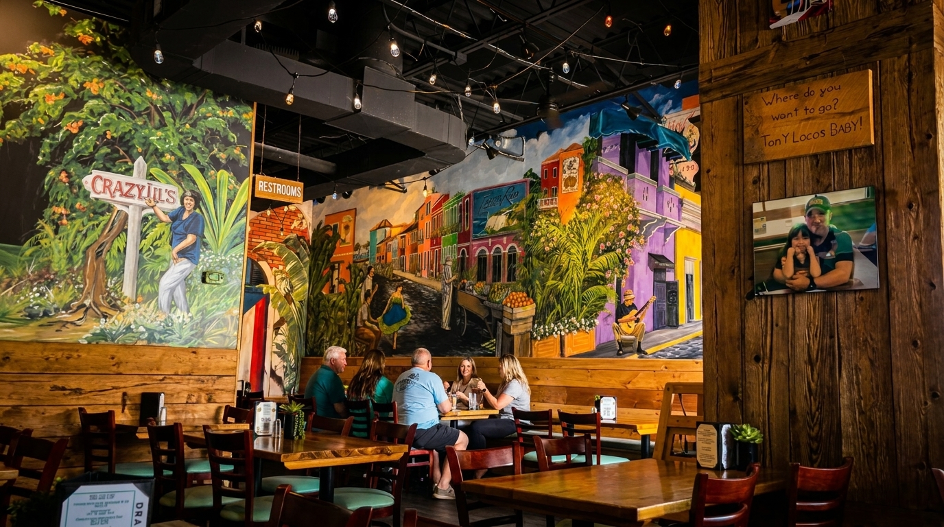 Restaurant interior with colorful murals, wooden tables, and people dining, featuring "Crazy Lil's" and "Tony Locos Baby" signs.