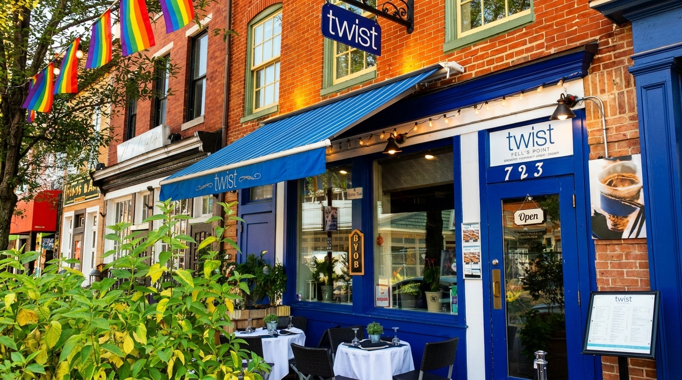 Twist restaurant exterior with blue awning, outdoor seating, and rainbow flags overhead.