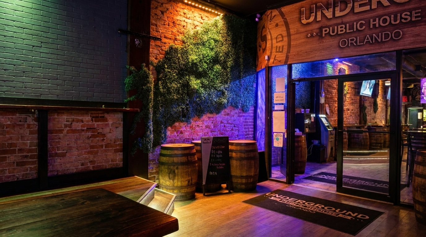 Entrance to Underground Public House Orlando, with brick walls, green foliage, and wooden barrels.