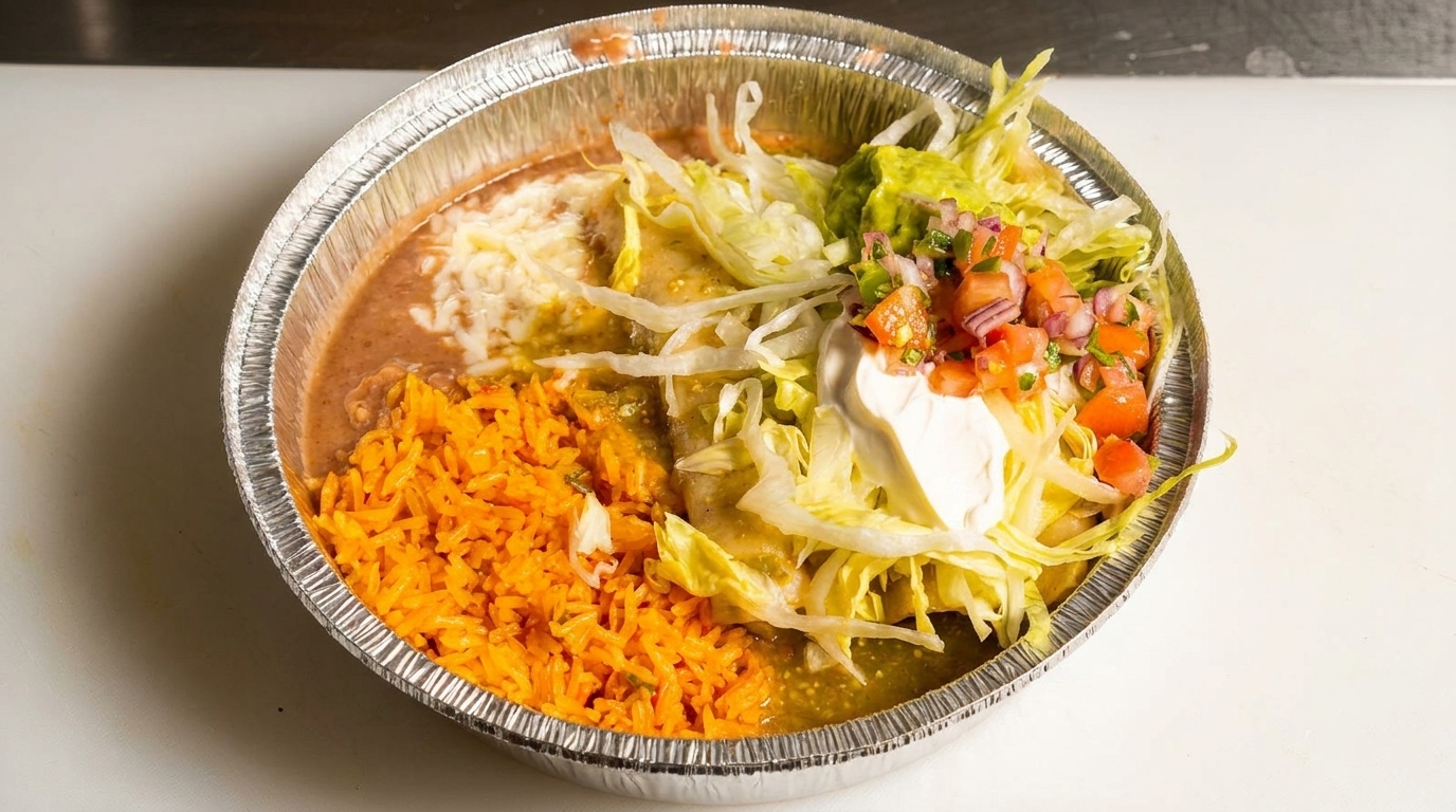 Mexican combination platter with rice, beans, enchiladas, lettuce, guacamole, pico de gallo, and sour cream.
