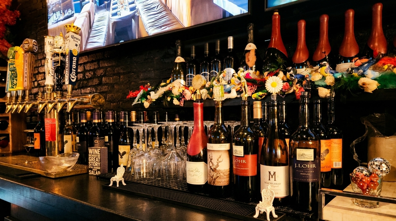 A bar counter with beer taps, wine bottles, wine glasses, and decorative items.