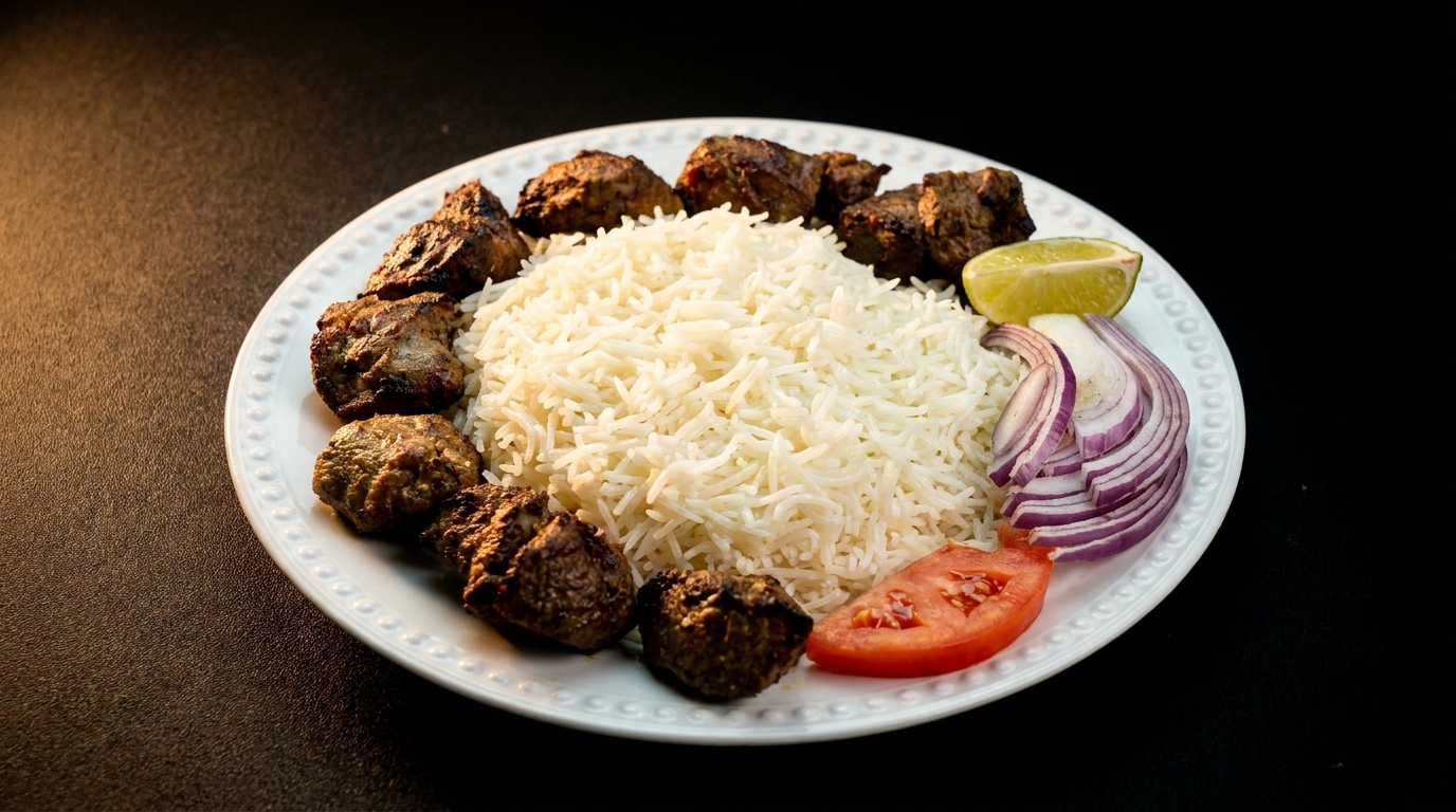 Grilled meat skewers arranged around a mound of white rice, with lime, red onion, and tomato.