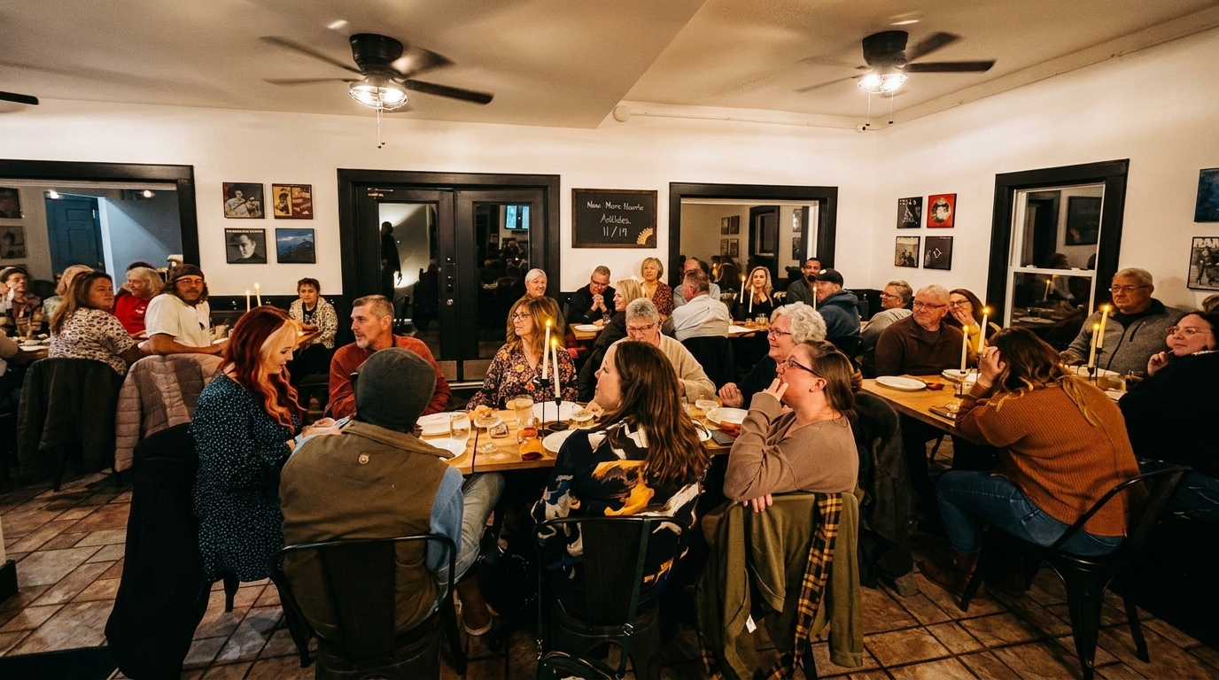 A lively restaurant dining room filled with diverse patrons enjoying a meal together at candlelit tables.