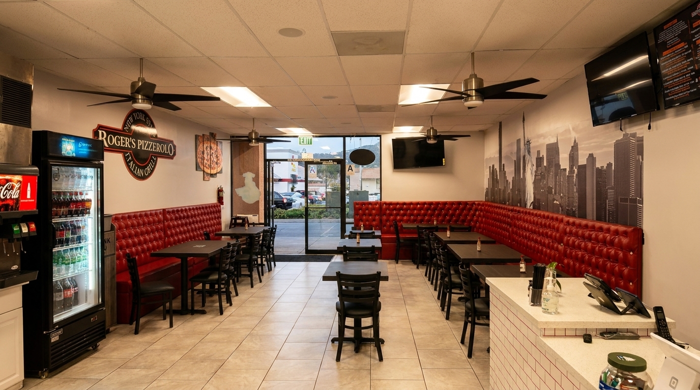 Roger's Pizzerolo restaurant interior with red booths, black tables, and a New York City skyline mural.